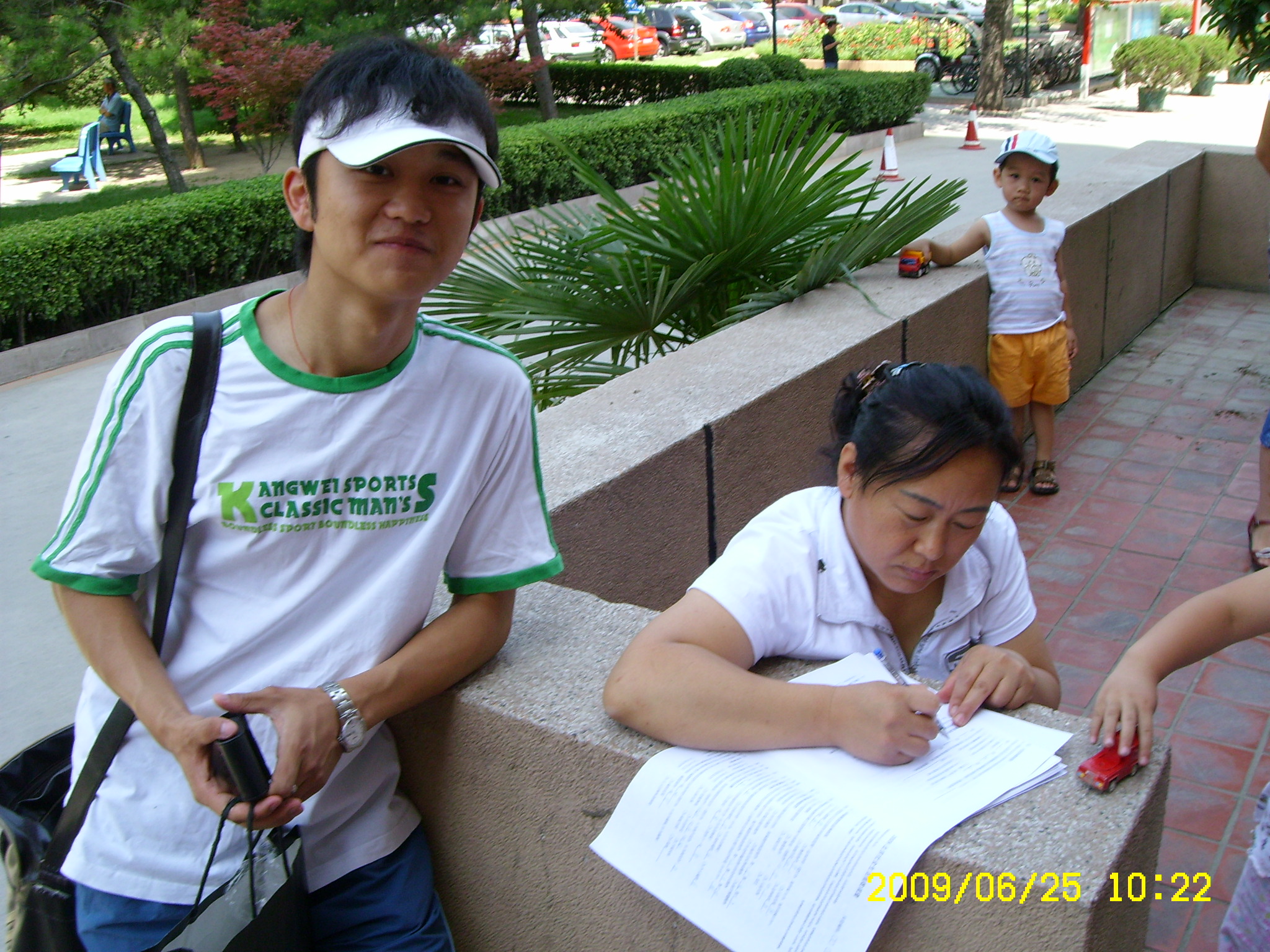 Alan Xu as an undergraduate, working as a survey enumerator with paper questionnaires.